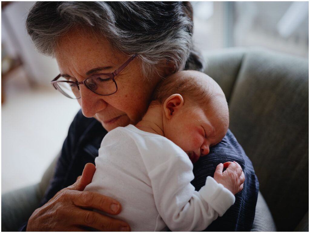 Grandmother and newborn baby cuddling.